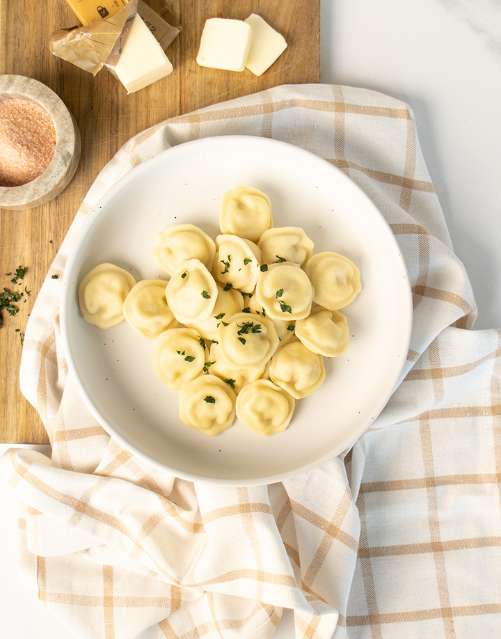 Luda's organic pelmeni, plated with sour cream