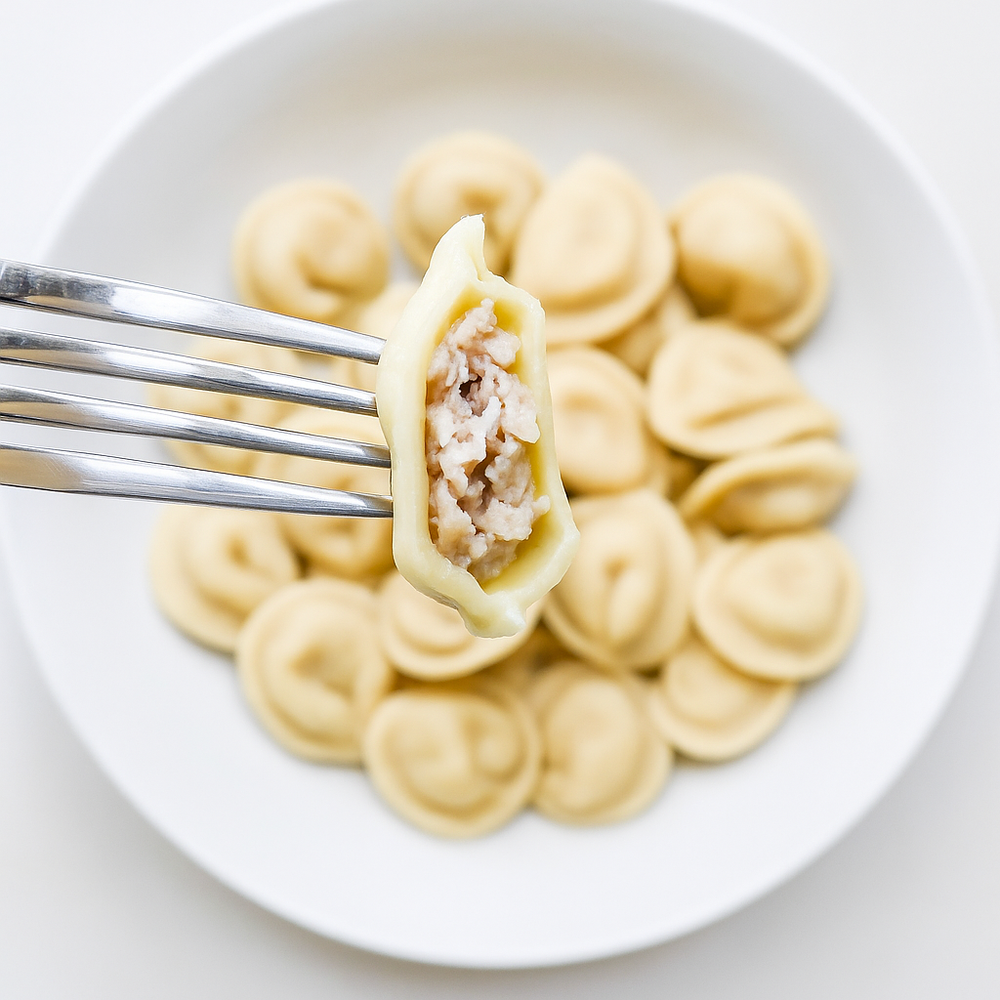 Cross-section of organic pelmeni showing seasoned meat filling